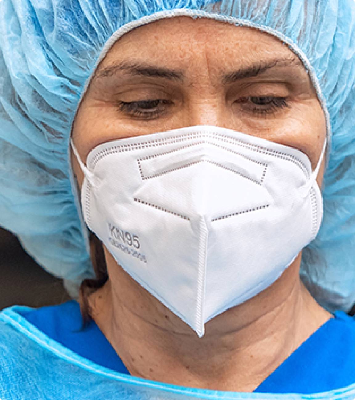 Close up of a health care worker's face as she has PPE on